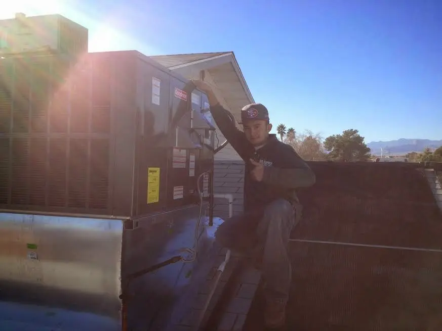 HVAC technician performing AC Tune-Up on a rooftop unit in Maple Shade